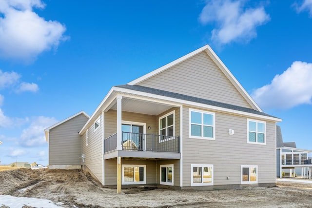 rear view of property featuring a balcony