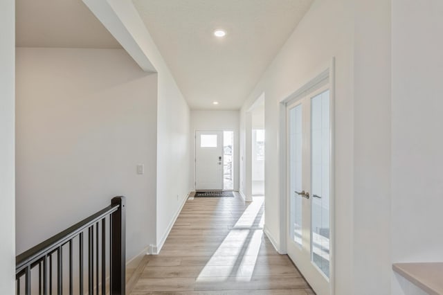 doorway featuring light wood-style flooring, recessed lighting, baseboards, and french doors