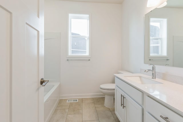 full bath with a wealth of natural light, toilet, tile patterned floors, and vanity