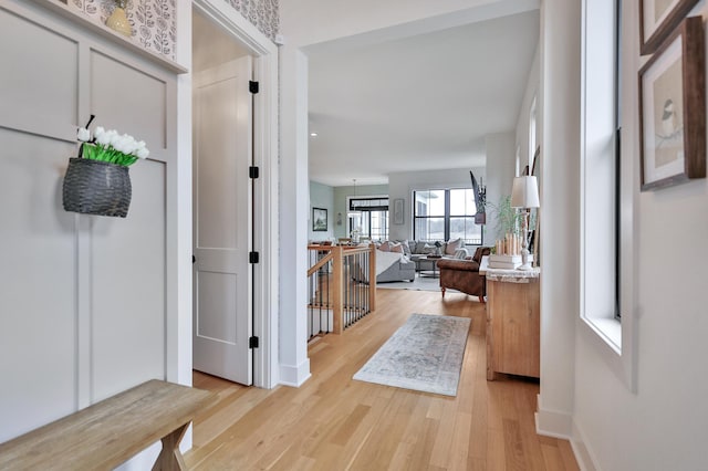 foyer with baseboards and light wood-style floors