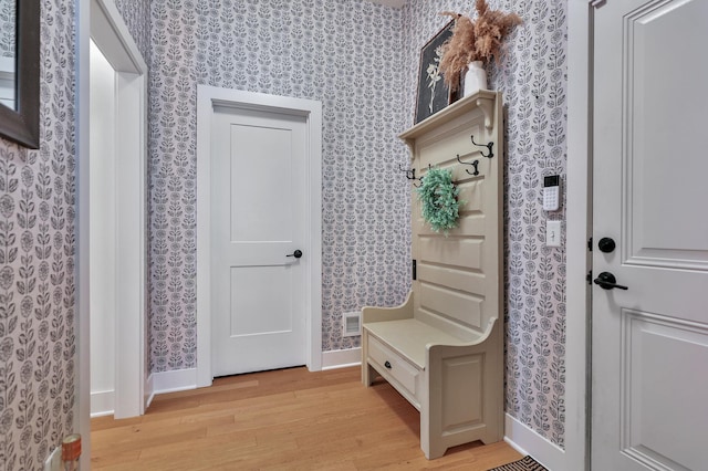 mudroom featuring baseboards, light wood-type flooring, and wallpapered walls