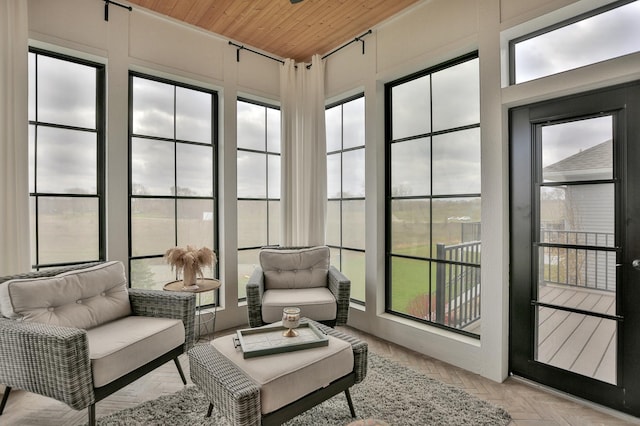 sunroom featuring wood ceiling