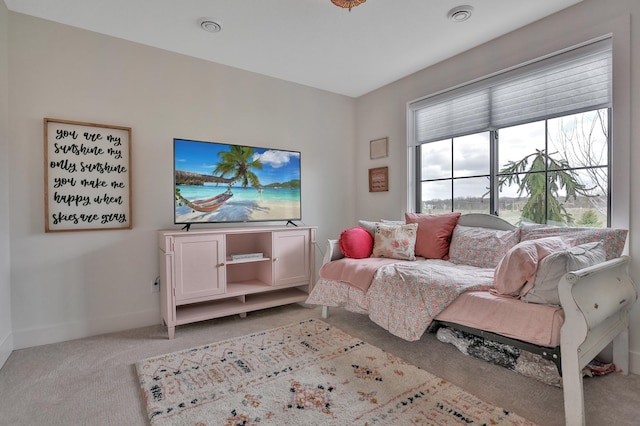 bedroom featuring light colored carpet and baseboards