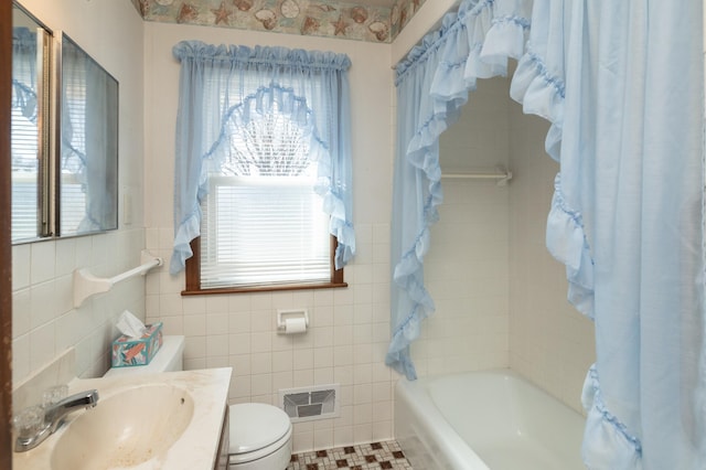 bathroom with shower / tub combo, visible vents, tile walls, and toilet