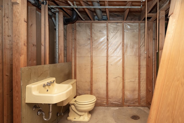 full bath with a stall shower, a sink, and toilet