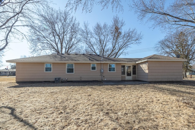 rear view of house with central AC unit