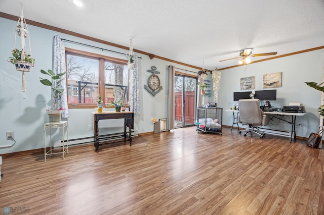 office with crown molding, baseboard heating, a textured ceiling, wood finished floors, and baseboards