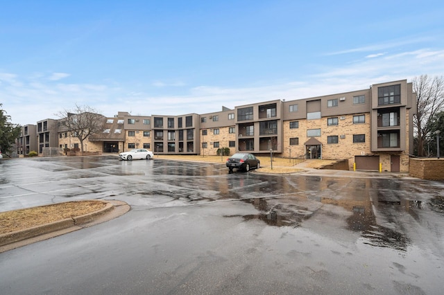 view of property featuring uncovered parking