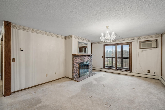 unfurnished living room with a textured ceiling, a baseboard heating unit, a brick fireplace, carpet, and an inviting chandelier