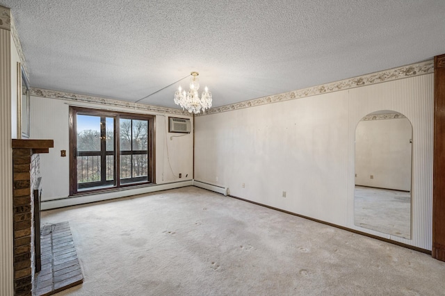 carpeted empty room featuring a baseboard heating unit, arched walkways, a notable chandelier, and a textured ceiling