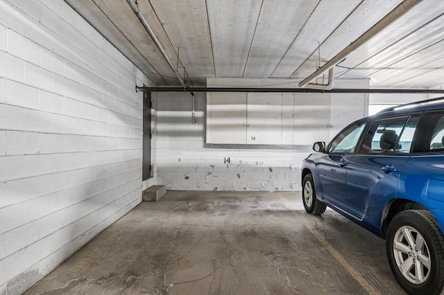 parking garage featuring concrete block wall