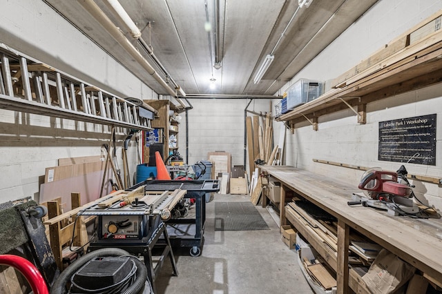 garage featuring a workshop area and concrete block wall