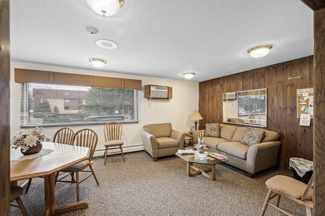 carpeted living area with a baseboard heating unit, plenty of natural light, wooden walls, and a wall mounted AC