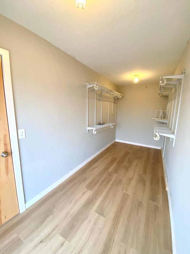 spacious closet featuring wood finished floors