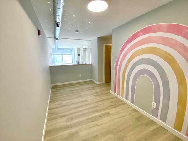 empty room with baseboards and wood finished floors