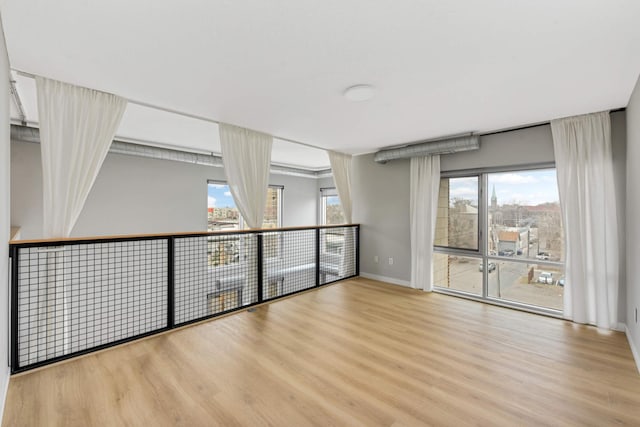 unfurnished room featuring wood finished floors and baseboards