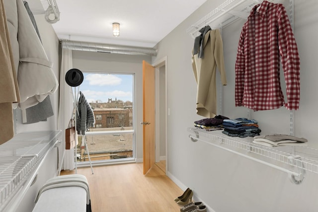 walk in closet featuring wood finished floors