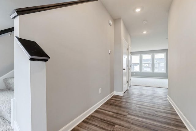 hall with stairway, baseboards, dark wood-type flooring, and recessed lighting