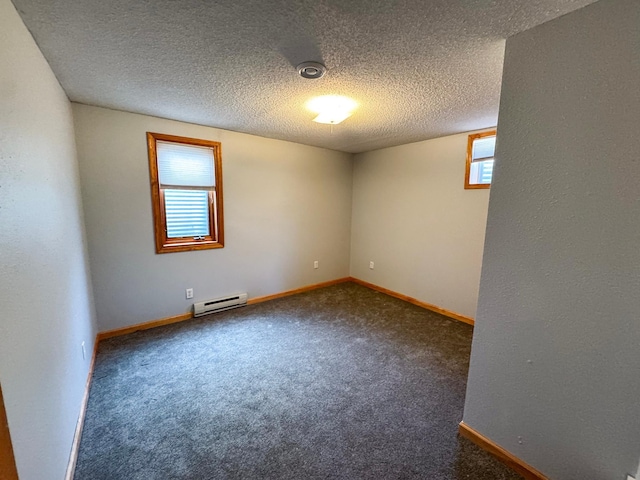 empty room featuring a baseboard heating unit, carpet floors, a textured ceiling, and baseboards