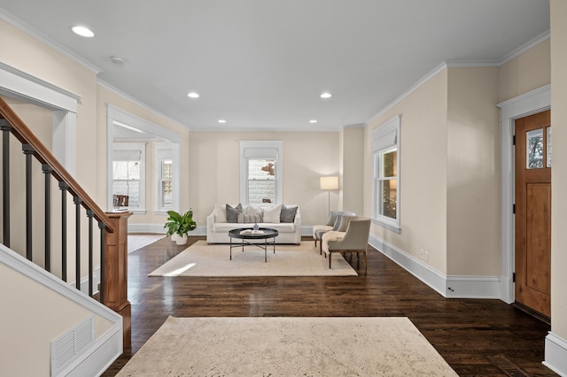 entrance foyer with ornamental molding, visible vents, dark wood finished floors, and stairs