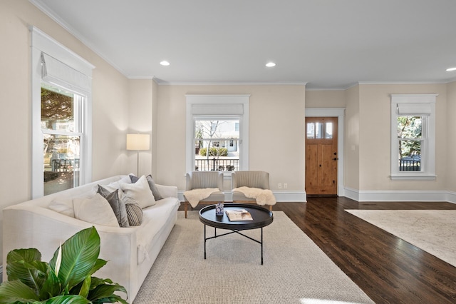 living room featuring baseboards, ornamental molding, wood finished floors, and recessed lighting