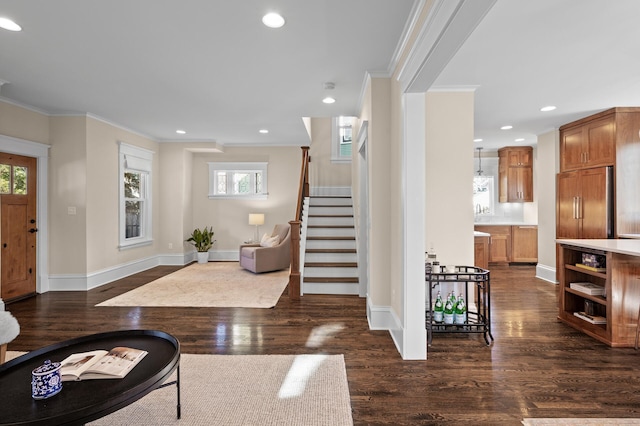 entryway with dark wood-style floors, stairway, crown molding, and recessed lighting