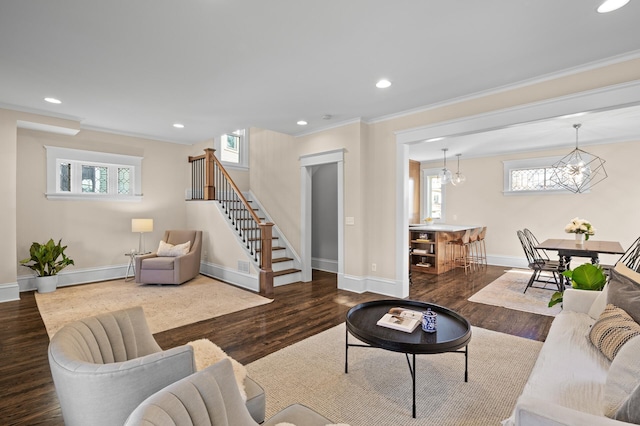 living area featuring ornamental molding, stairway, and wood finished floors