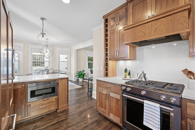 kitchen featuring a wealth of natural light, built in microwave, stainless steel gas stove, and custom exhaust hood