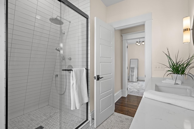 bathroom featuring a stall shower, vanity, and wood finished floors