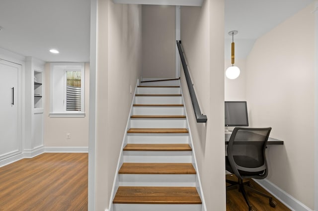 stairway with baseboards, wood finished floors, and recessed lighting