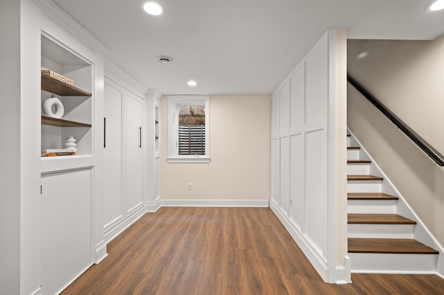 interior space with stairs, baseboards, dark wood-style flooring, and recessed lighting