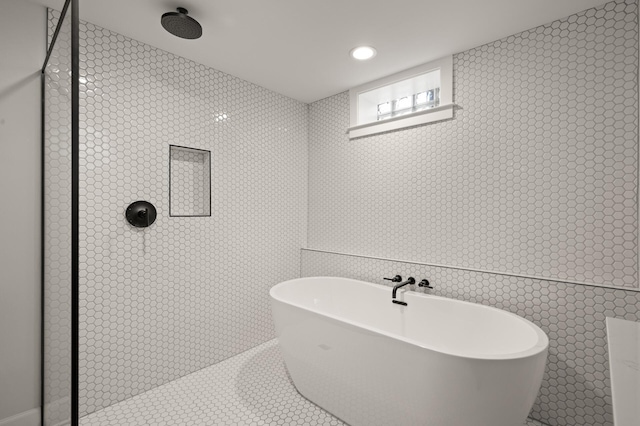 full bathroom featuring recessed lighting, a soaking tub, tiled shower, and tile patterned floors