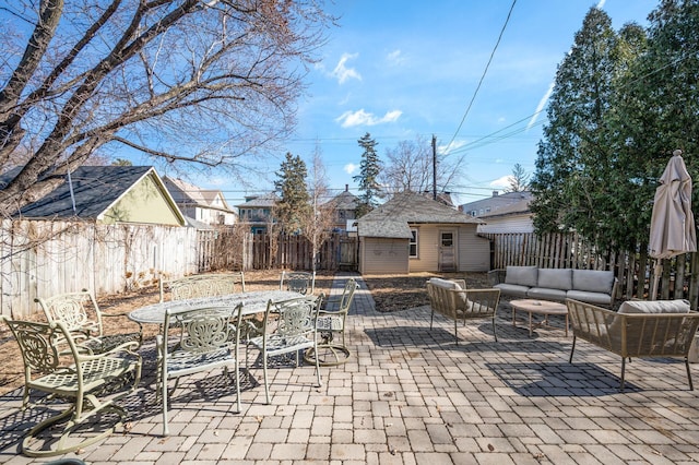 view of patio / terrace featuring outdoor dining space, outdoor lounge area, an outdoor structure, and a fenced backyard