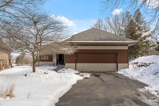 view of front facade with driveway and an attached garage