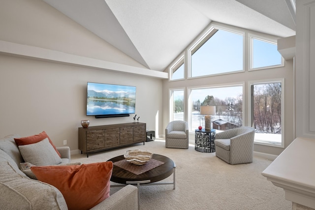 living room with a healthy amount of sunlight, carpet, and high vaulted ceiling