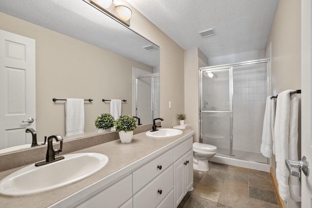 bathroom featuring a sink, visible vents, and a shower stall