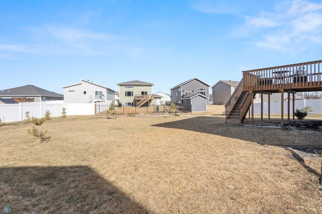 752 Cathy Dr W, West Fargo, ND 58078 - view of yard featuring stairs, a deck, a fenced backyard, and a residential view