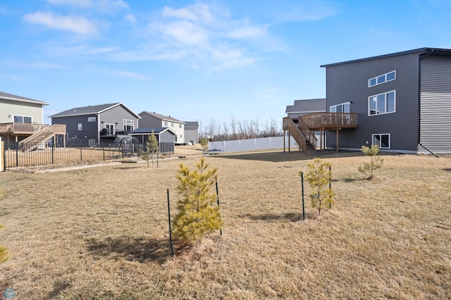 752 Cathy Dr W, West Fargo, ND 58078 - view of yard featuring stairway, a wooden deck, a residential view, and fence