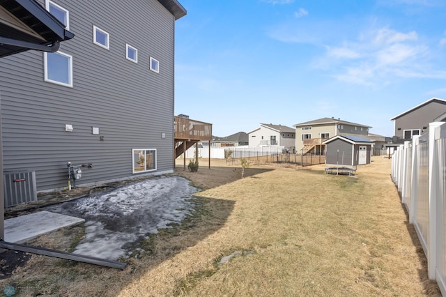 752 Cathy Dr W, West Fargo, ND 58078 - view of yard with a shed, a residential view, a wooden deck, a fenced backyard, and an outdoor structure