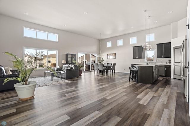 752 Cathy Dr W, West Fargo, ND 58078 - living area with dark wood-style floors, baseboards, and a towering ceiling