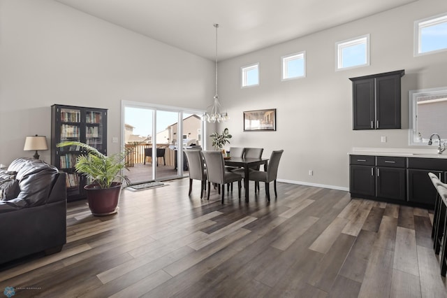752 Cathy Dr W, West Fargo, ND 58078 - dining area featuring dark wood finished floors, a high ceiling, plenty of natural light, and a chandelier