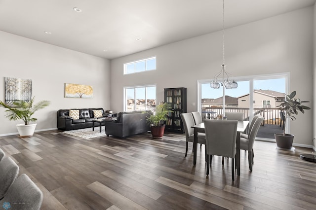 752 Cathy Dr W, West Fargo, ND 58078 - dining space with dark wood finished floors, a notable chandelier, baseboards, and a towering ceiling