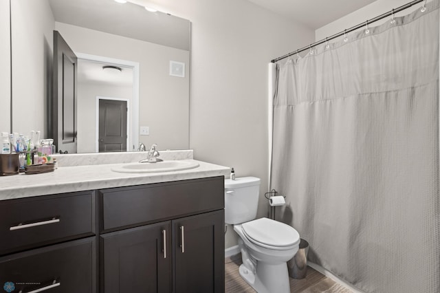 752 Cathy Dr W, West Fargo, ND 58078 - full bathroom featuring vanity, toilet, wood finished floors, and visible vents