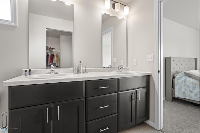752 Cathy Dr W, West Fargo, ND 58078 - full bath with double vanity, connected bathroom, baseboards, and a sink