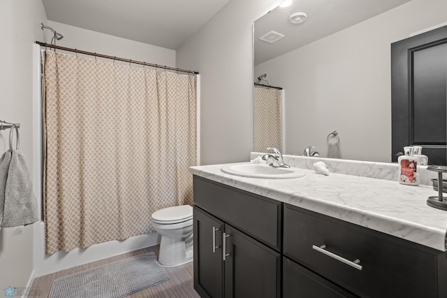 752 Cathy Dr W, West Fargo, ND 58078 - bathroom with vanity, wood finished floors, visible vents, shower / bath combo, and toilet