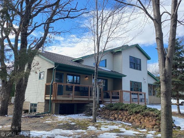 snow covered property with a shingled roof