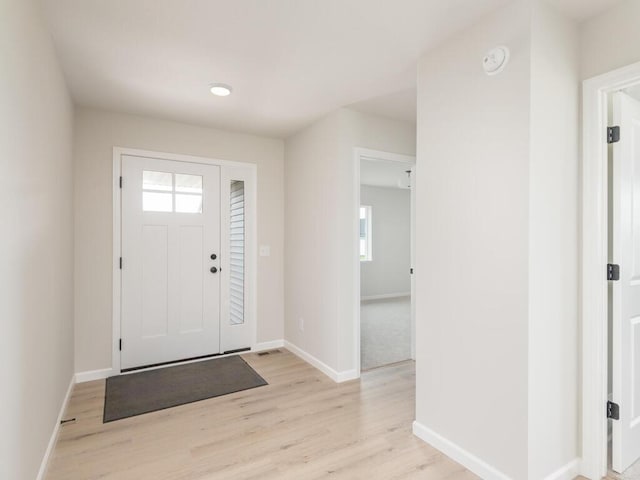 entryway featuring light wood-style floors and baseboards