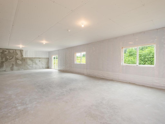 spare room featuring unfinished concrete flooring