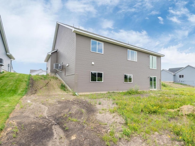 rear view of property featuring a yard