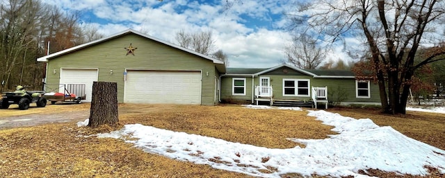 ranch-style house featuring an attached garage and driveway